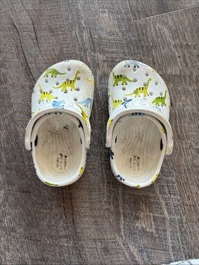 CROCS Kids Buzz Lightyear and White Clogs with Green & Blue Dinosaur